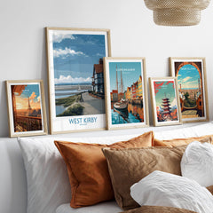 West Kirby Canvas Art Print displayed among other city art prints on a stylish shelf above a cozy sofa.
