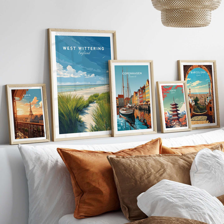 West Wittering UK travel poster surrounded by framed coastal art prints in stylish home decor setting.