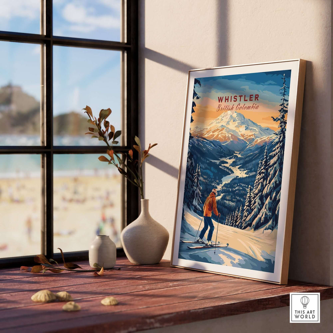 Whistler Travel Poster showcasing British Columbia's ski slopes, framed and displayed next to a window with beach view.