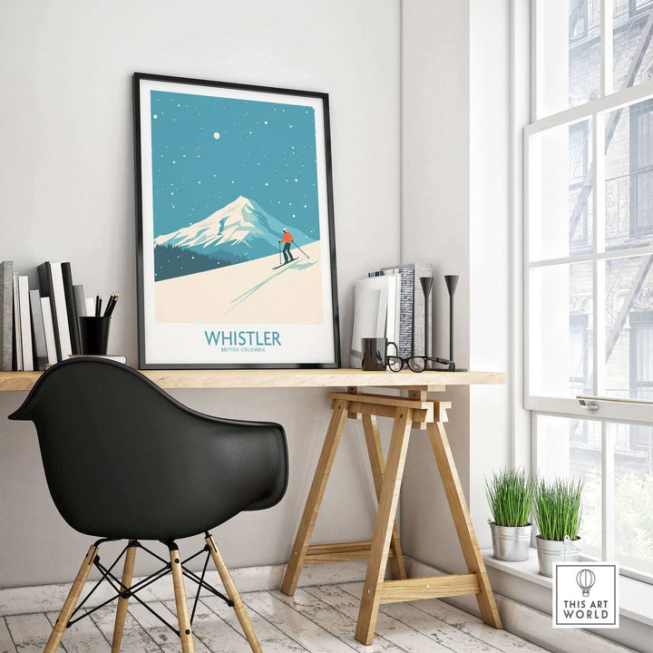 Whistler Wall Art Print featuring a ski poster of British Columbia displayed on a modern desk with a chair in a sunlit room.