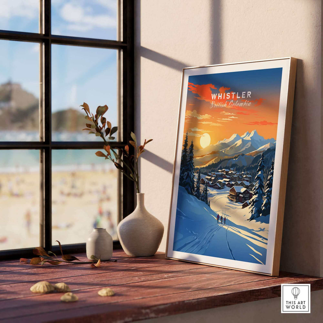 Whistler Ski Poster Wall Art Print showcasing a winter scene with mountains and sunset, displayed on a windowsill.