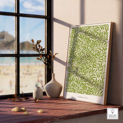 Exhibition Art Print William Morris Willow Pattern Green Botanical Wall Art displayed by a window with beach view.
