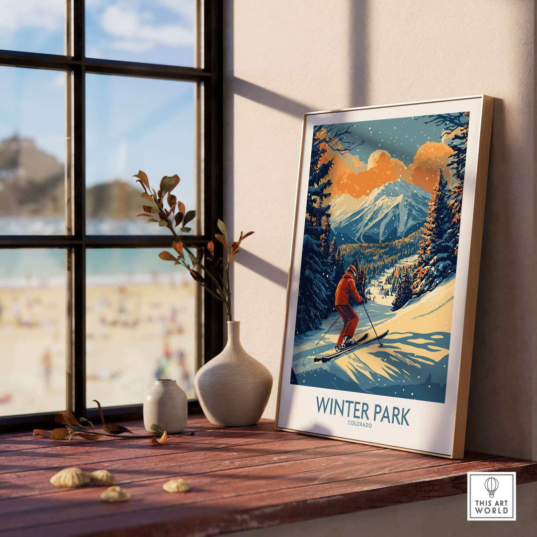 Winter Park Colorado ski poster on a wooden table with mountain scene and skier, sunlight streaming through window.