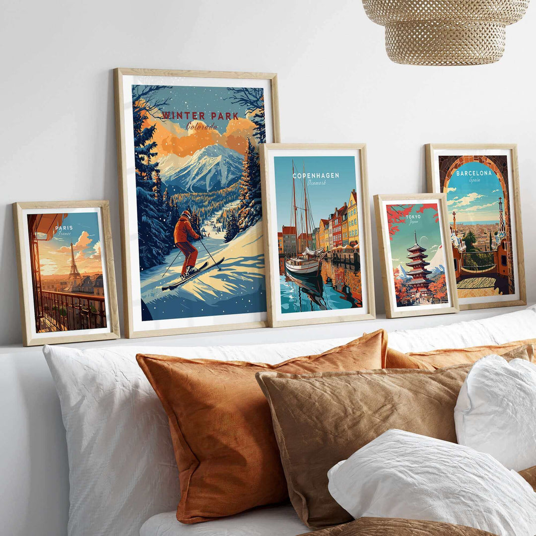 Winter Park ski poster framed on a shelf, featuring snowy mountains, alongside artistic prints of Copenhagen and Barcelona.