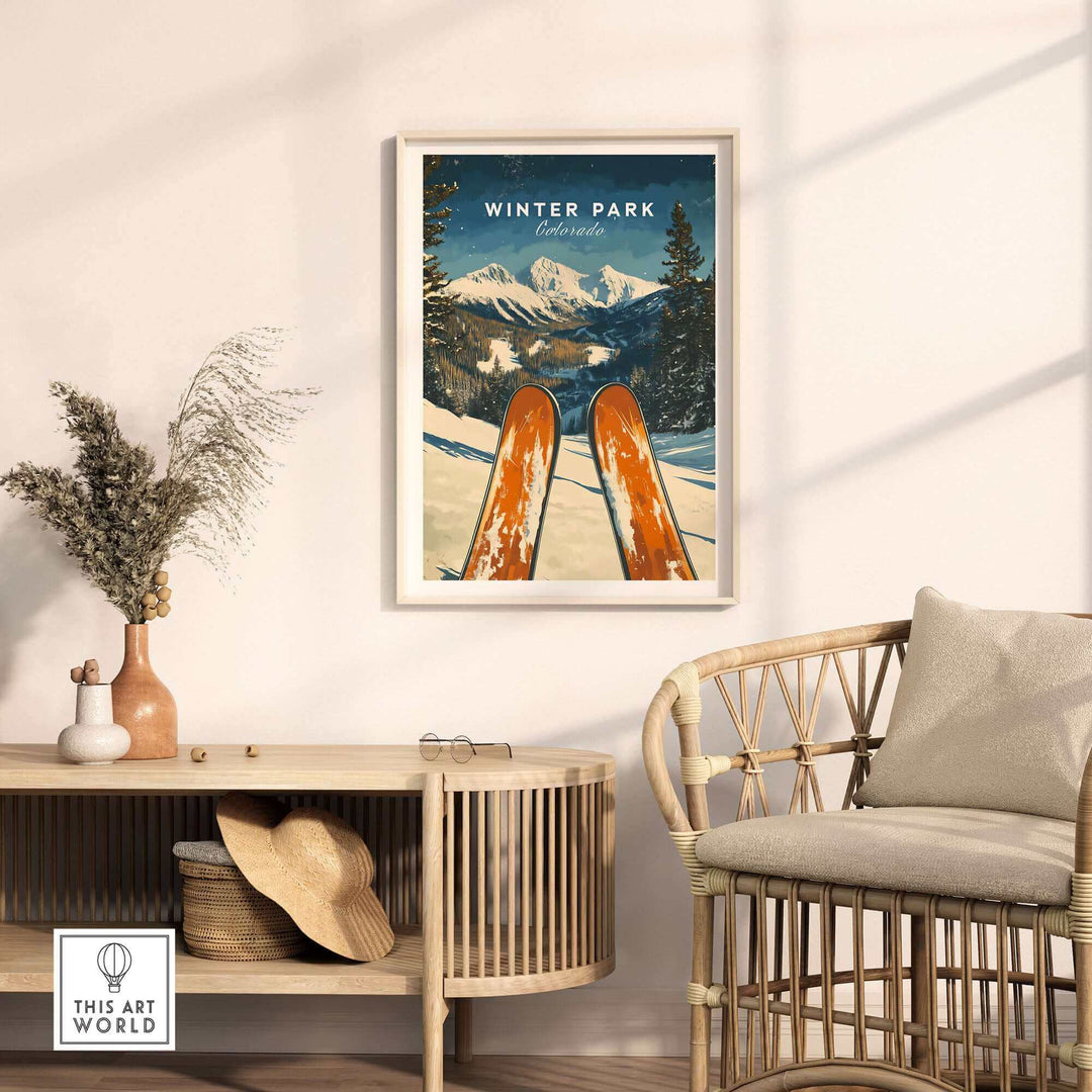 Winter Park Ski Poster featuring snowy Colorado mountains in a cozy living space with natural decor and rattan chair.