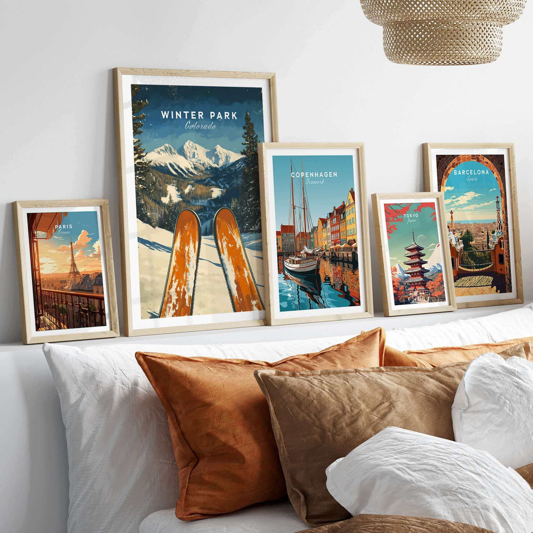 Collection of travel posters featuring Winter Park Ski Poster, Colorado, and other scenic locations displayed on a modern shelf.