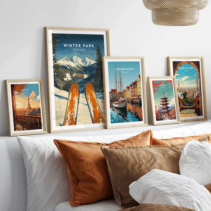 Collection of travel posters featuring Winter Park Ski Poster, Colorado, and other scenic locations displayed on a modern shelf.