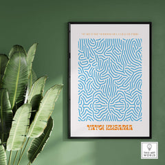 Yayoi Kusama Blue Infinity Net Pattern Abstract Art Print Paris Exhibition Poster framed on a green wall with plants.