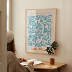 Yayoi Kusama Blue Infinity Net Pattern Abstract Art Print Paris Exhibition Poster displayed on a wall in a cozy interior setting.