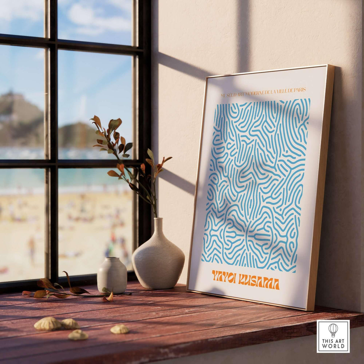Yayoi Kusama Blue Infinity Net Pattern Abstract Art Print Paris Exhibition Poster displayed by a window with beach view.