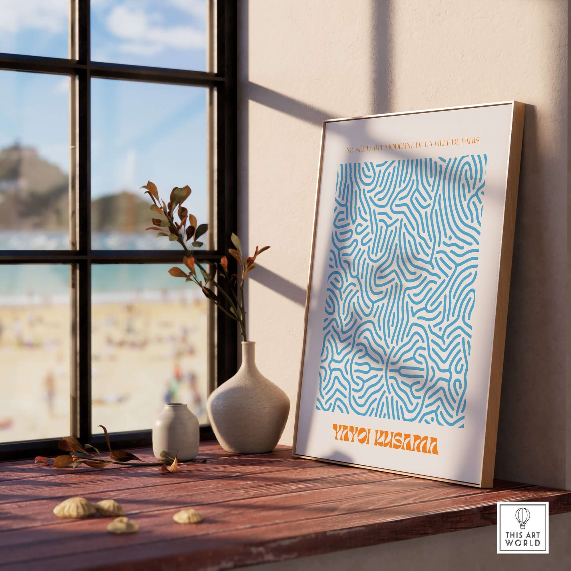 Yayoi Kusama Blue Infinity Net Pattern Abstract Art Print Paris Exhibition Poster displayed by a window with beach view.