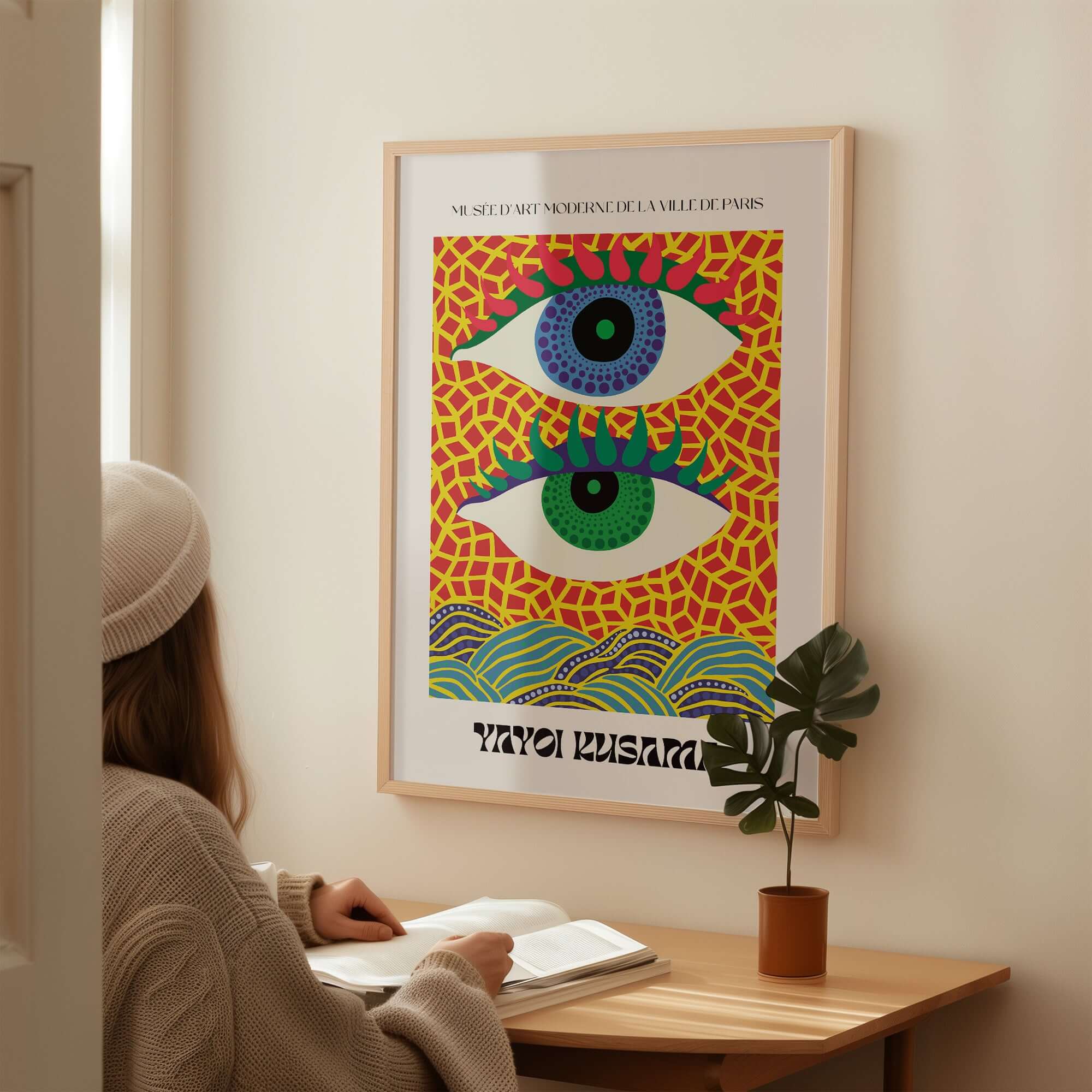 Yayoi Kusama Colorful Eyes Abstract Pattern Contemporary Art Print Paris Poster displayed on a wall with a person admiring it.