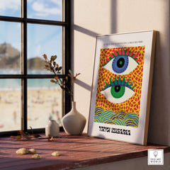 Yayoi Kusama Colorful Eyes Abstract Pattern Contemporary Art Print Paris Poster displayed in a bright room with beach view.