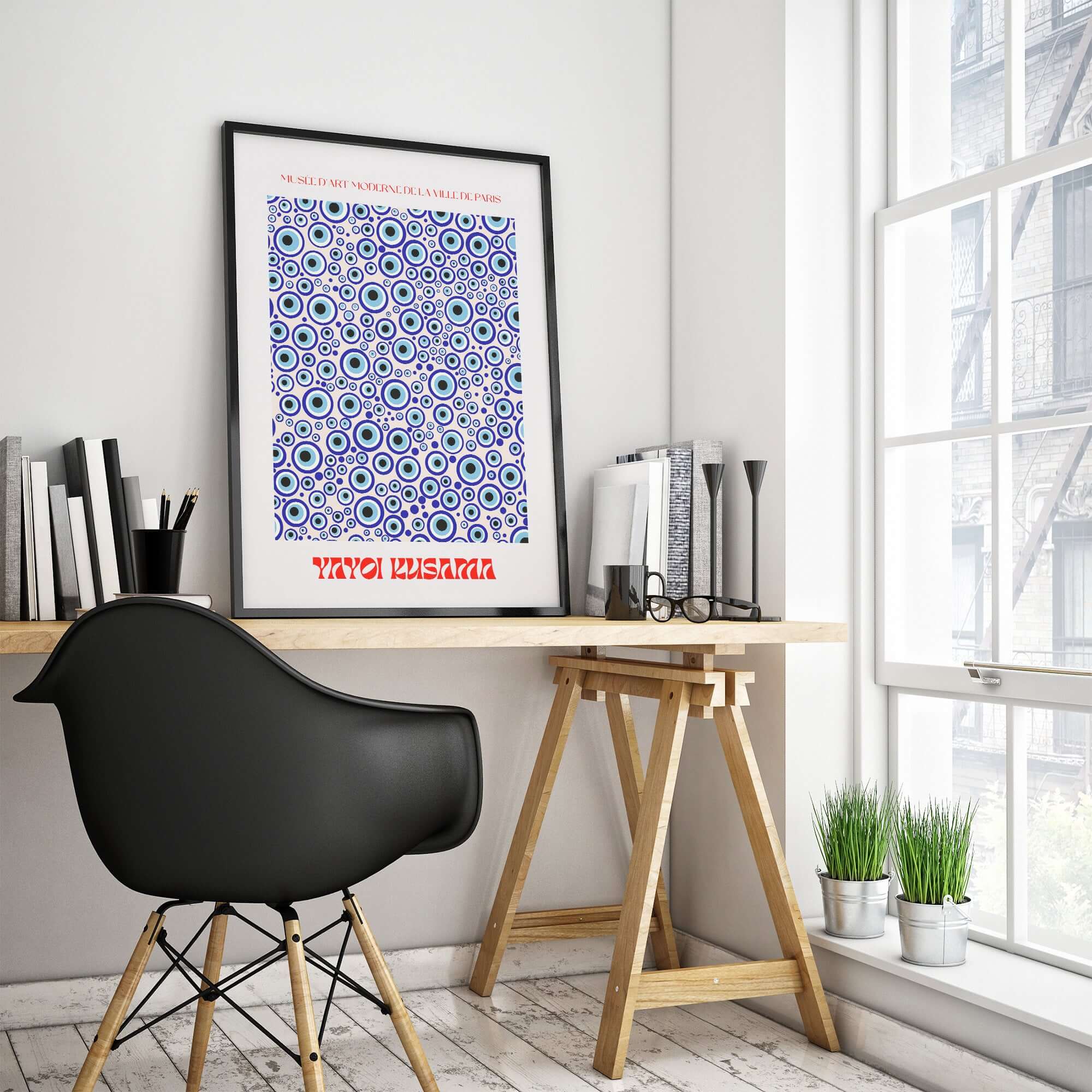 Yayoi Kusama Evil Eye Pattern Blue Contemporary Art Print Poster Paris Wall Decor framed in a modern workspace.