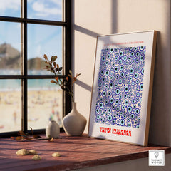 Yayoi Kusama Evil Eye Pattern Blue Contemporary Art Print Poster Paris Wall Decor displayed on a windowsill with beach view.