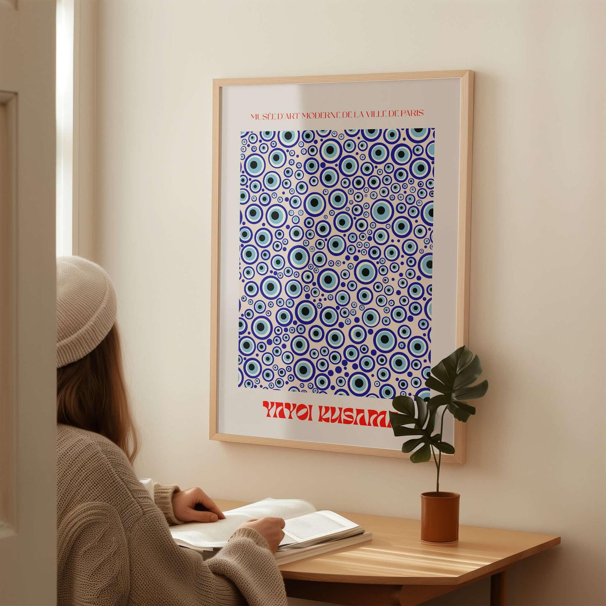 Yayoi Kusama Evil Eye Pattern Blue Contemporary Art Print Poster Paris Wall Decor displayed in a cozy interior.