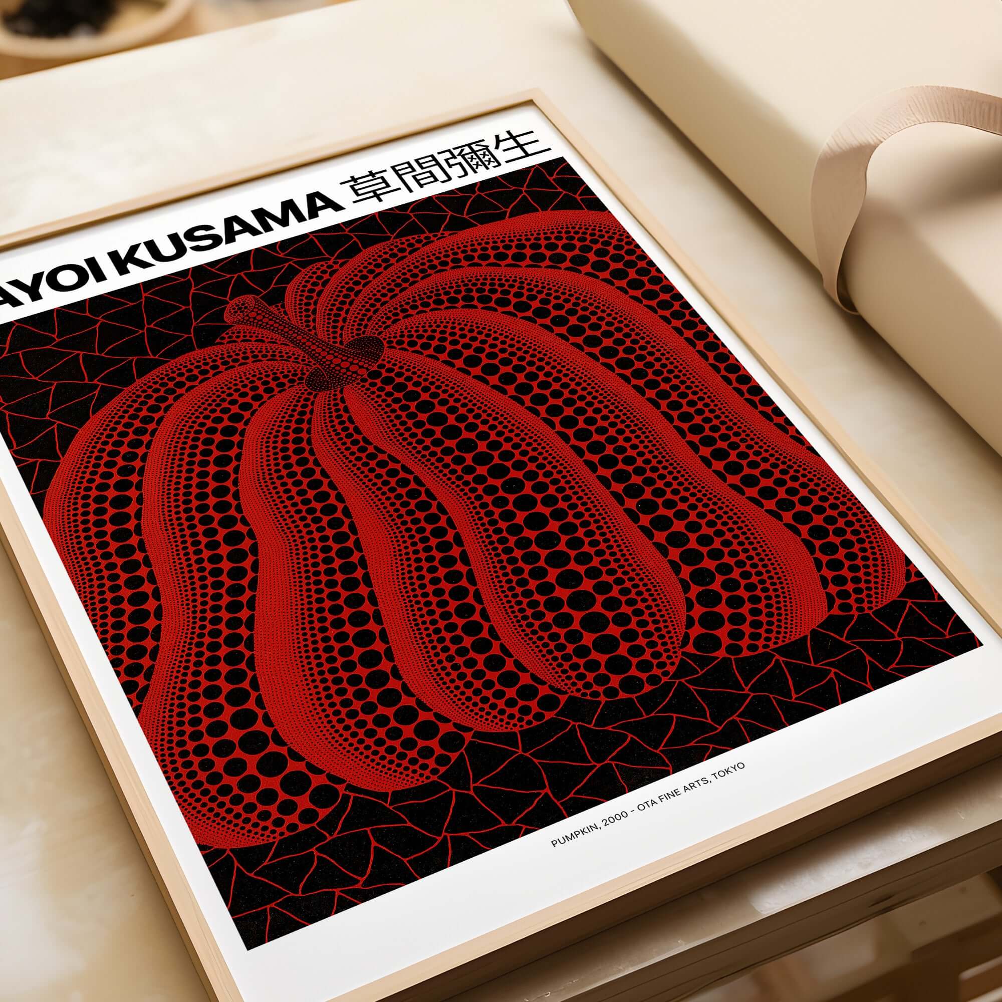 Yayoi Kusama Red Black Pumpkin art print featuring bold red pumpkin with black polka dots on a black net background.