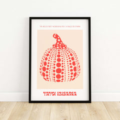 Yayoi Kusama Red Pumpkin Polka Dot Pop Art Print Poster Paris Exhibition Wall Art in a black frame on a wooden floor.