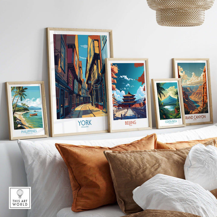 Framed prints of York, Beijing, Costa Rica, and the Philippines displayed above a cozy sofa, showcasing global scenic art.