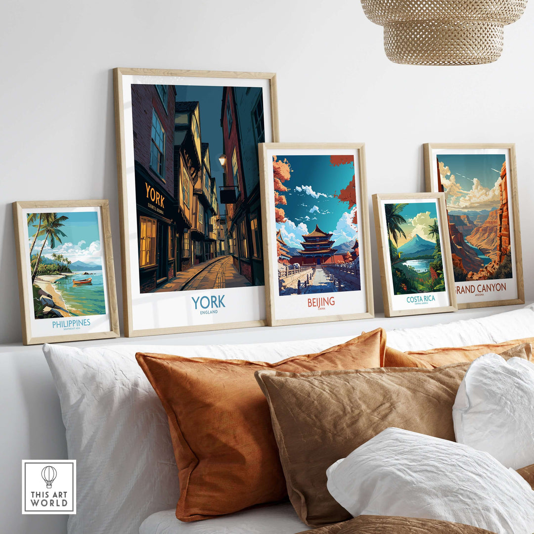 Framed cityscape posters including York, Beijing, Philippines, Costa Rica, and Grand Canyon on a cozy couch.