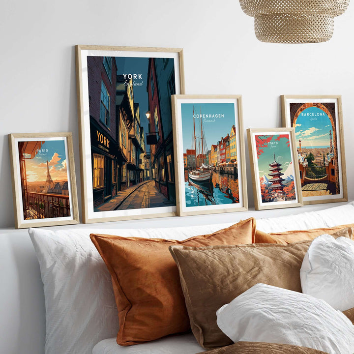Framed prints of illuminated York alleyway and other cityscapes on a cozy bed decor showcasing wall art.