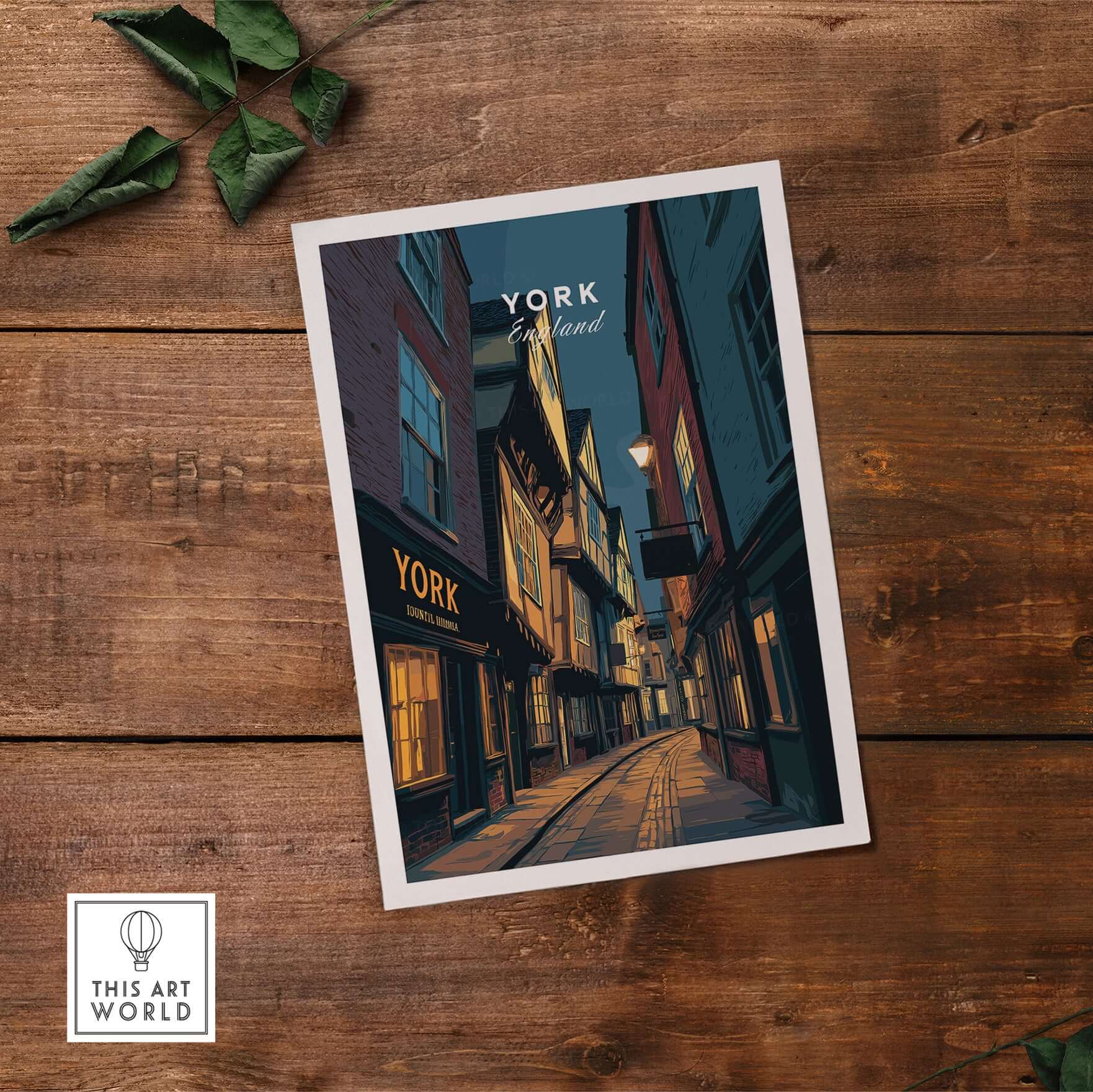 York England Shambles Print - Illuminated York Alleyway Wall Art on a wooden table with green foliage.
