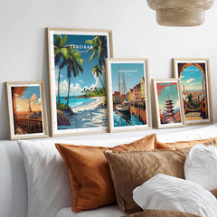Zanzibar Wall Art Print displayed with travel posters of Copenhagen and Barcelona on a stylish bed.