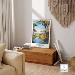 Zimbabwe Poster - African Safari Wall Art - Giraffe and Elephant Print displayed in a cozy living room setting.