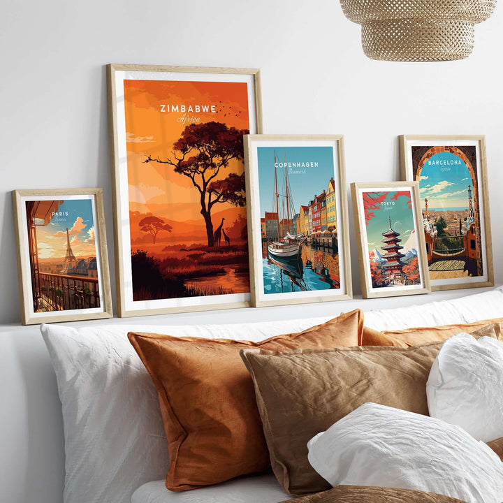 Framed Zimbabwe poster and other city prints displayed on a stylish bed, showcasing vibrant travel artwork.