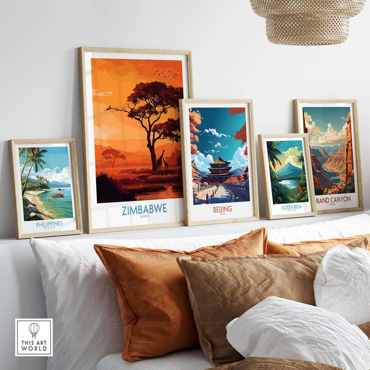 A stylish display of travel posters, including Zimbabwe, Philippines, Beijing, Costa Rica, and the Grand Canyon, on a cozy couch.