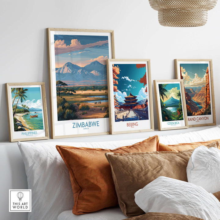 Collection of travel posters, featuring Zimbabwe, Beijing, Philippines, Costa Rica, and Grand Canyon on a cozy couch.