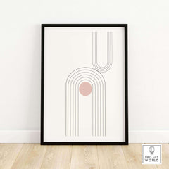Framed abstract art print with geometric lines and a soft pink circle, enhancing modern home decor.
