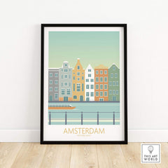 Amsterdam Print artwork framed on a wall, featuring colorful buildings and a canal, showcasing modern travel art.