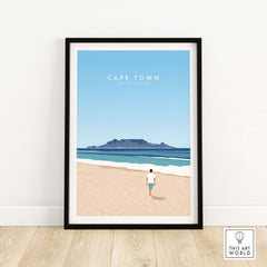 Cape Town print featuring a beach scene and Table Mountain, framed artwork from This Art World, perfect for travel lovers.