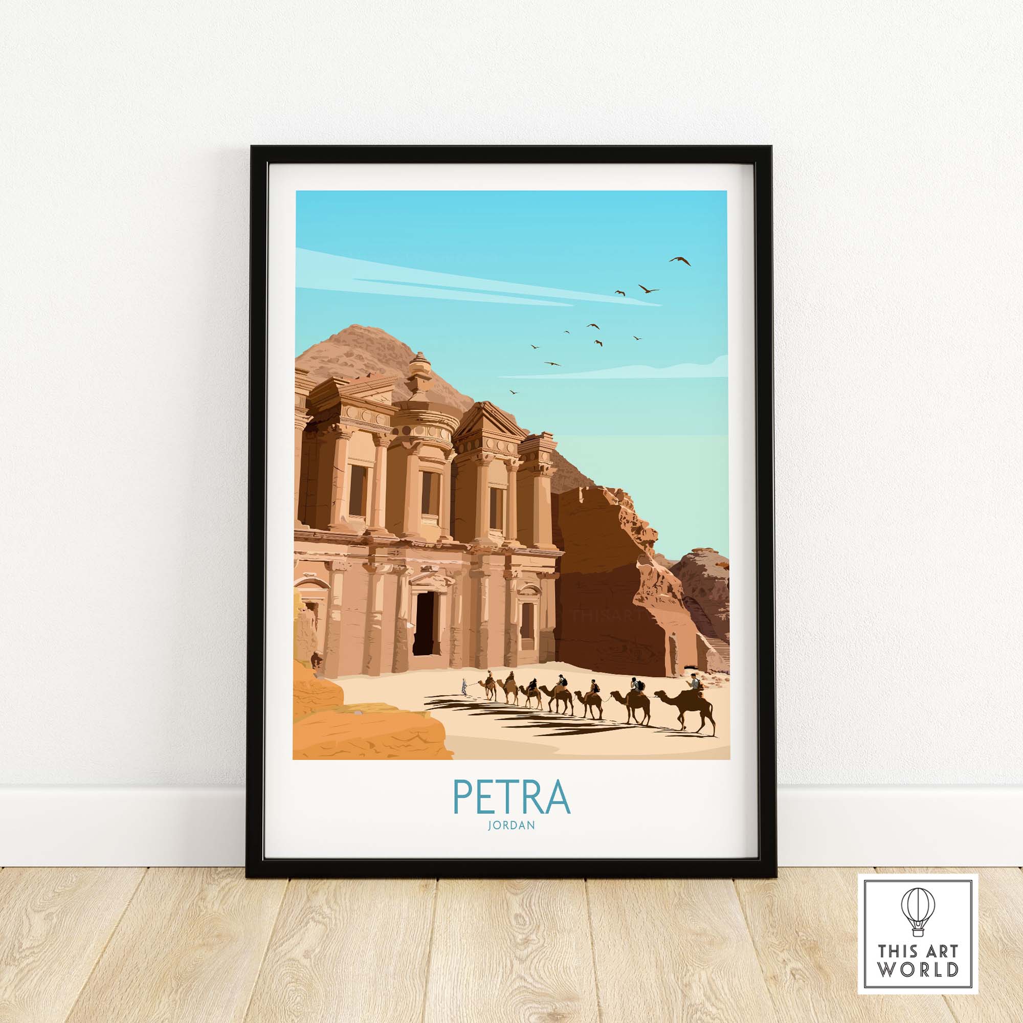 Framed Petra Wall Art Print depicting ancient city of Petra, Jordan, with camel caravan and blue sky.
