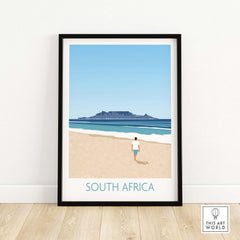 South Africa wall art print featuring a person walking on a beach with Table Mountain in the background.