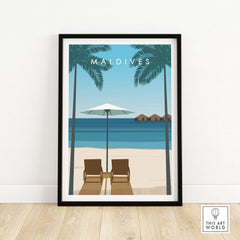 Maldives poster showcasing white sandy beach, palm trees, and two lounge chairs under an umbrella for vacation inspiration.