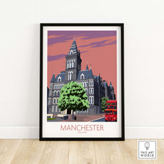 Framed Manchester Art Print featuring vintage architecture and a red double-decker bus against a pastel sky.