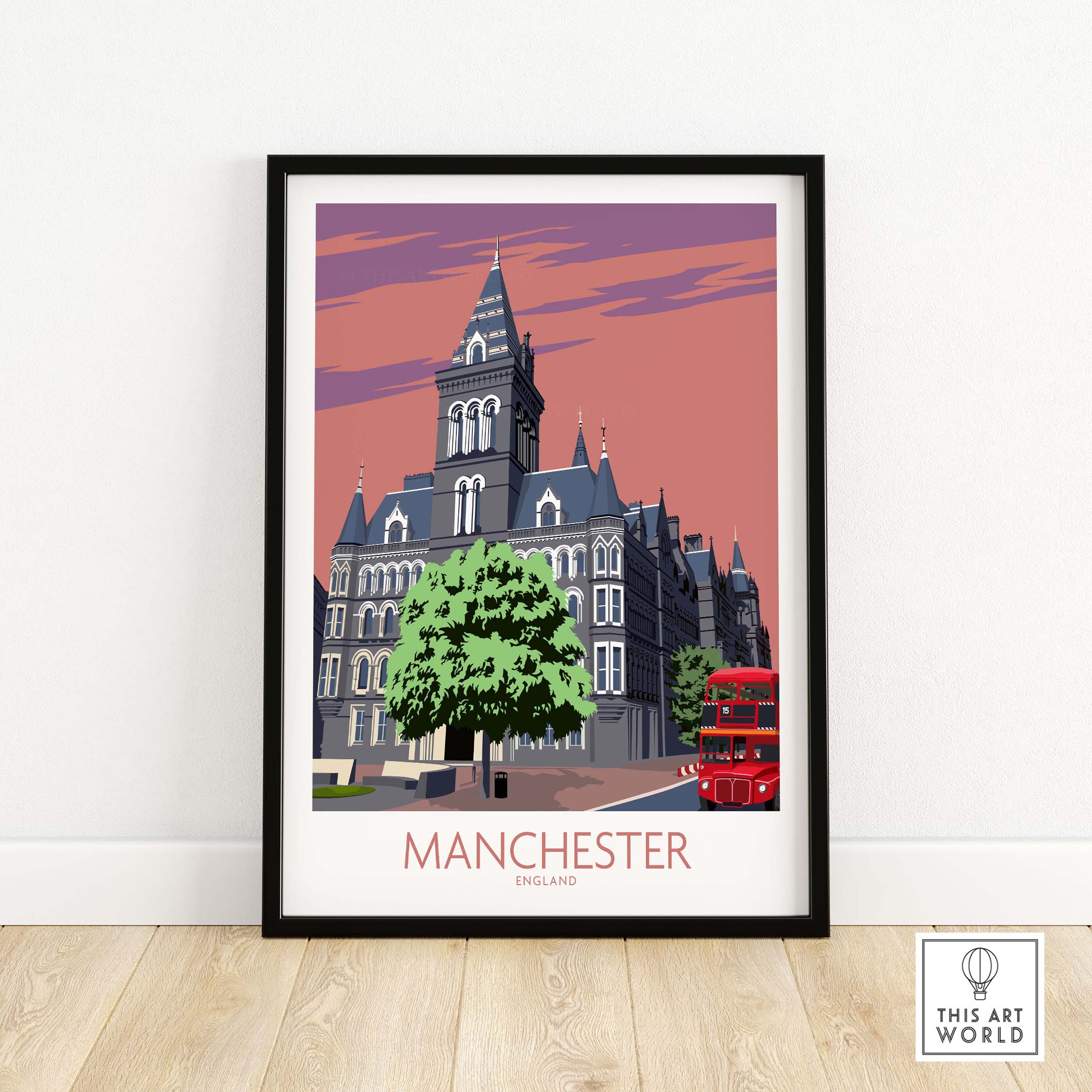 Framed Manchester Art Print featuring vintage architecture and a red double-decker bus against a pastel sky.