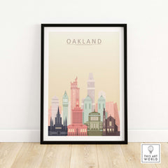 Oakland city skyline art print in pastel colors, framed and displayed on a light wooden floor.