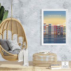 Amsterdam wall art poster print showcasing colorful canal houses, set in a stylish home interior with a hanging chair.