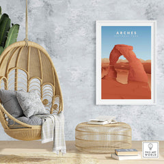 Framed Arches National Park art print displayed in a stylish interior with a hanging chair and natural decor.