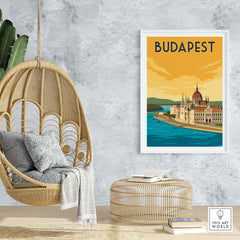 Budapest vintage print poster wall art displayed in a stylish home setting with a hanging chair and rattan furniture.