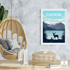 Canada Poster Wall Art Print featuring mountains, a lake, and a deer in a cozy home setting.