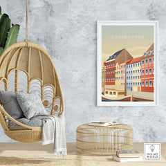 Copenhagen wall art poster in a stylish setting with a hanging chair and modern decor showcasing travel inspiration.