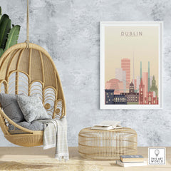 Dublin skyline wall art in warm pastel tones displayed in a cozy interior with a hanging chair and rattan furniture.