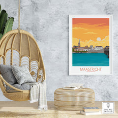 Stylish Maastricht travel poster artwork displayed on a wall above a hanging chair and a round coffee table.