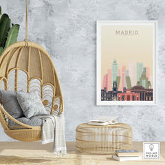 Madrid skyline print in warm pastel tones displayed in a modern living space with hanging chair and rattan decor.
