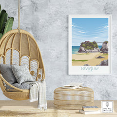 Newquay Cornwall travel poster hanging in a stylish interior with a hanging chair and natural decor.