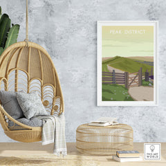 Peak District travel poster print in a stylish home setting with a hanging chair and decorative elements.